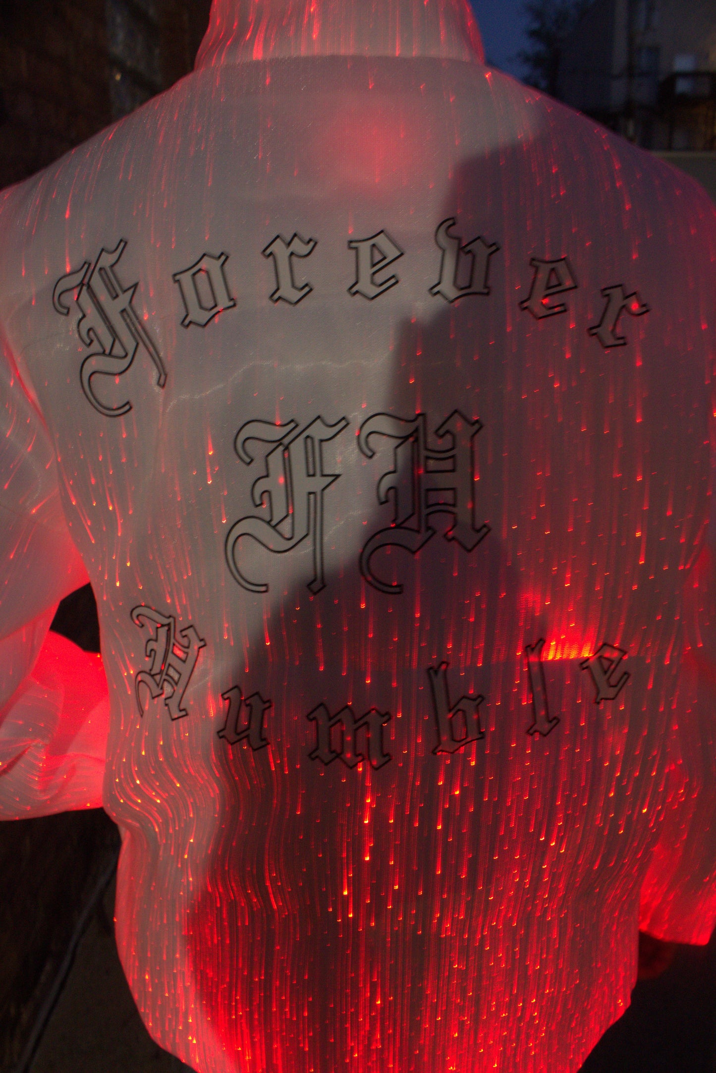 Red glowing object with black text on a puffer jacket