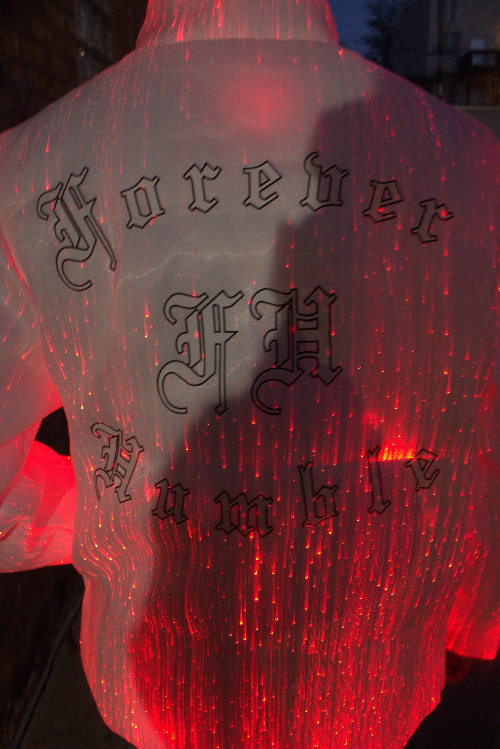Red glowing object with black text on a puffer jacket