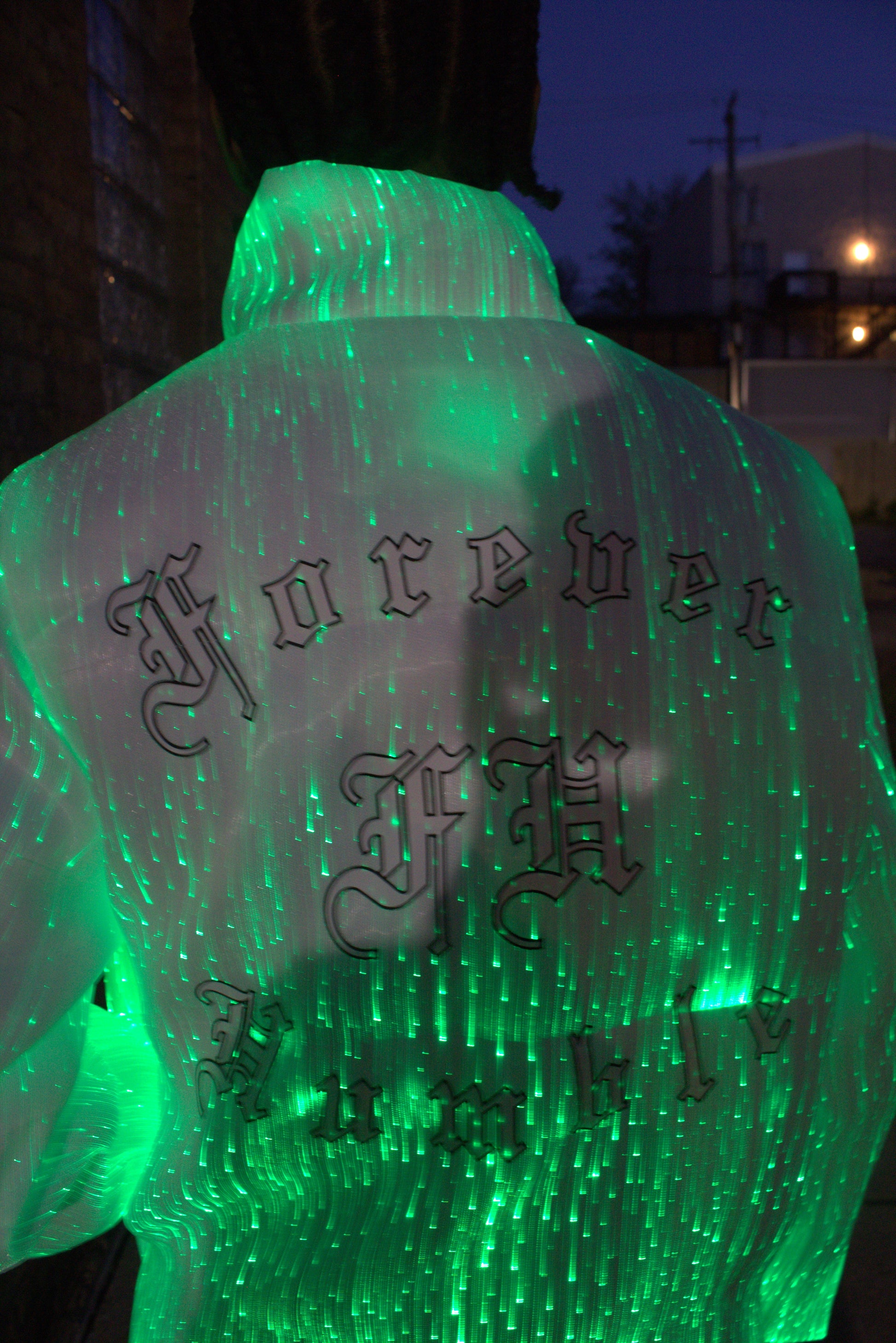 Green illuminated object with Chinese characters on a puffer jacket